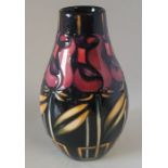 A boxed Moorcroft vase, decorated in the Night Rose pattern  , decorated with red roses on a black