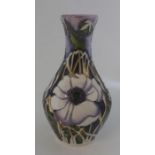 A Boxed Moorcroft vase titled  " Peace Anemone " it is decorated in shades of lilacs with large