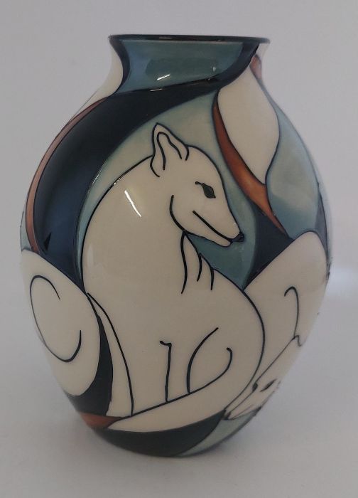 A Boxed Moorcroft vase titled  " Artic Fox"  it is decorated with a banded group of white artic