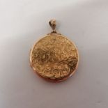 An early 20th century 9ct gold large round locket. Marked for Birmingham 1915. Featuring an engraved