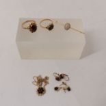 A selection of gold and yellow metal jewellery comprising: a garnet cabochon set ring in unmarked