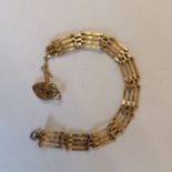 A 9ct gold gate bracelet with a heart padlock clasp. In as found condition. Gross weight