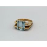 A topaz set modernist ring, with a split shouldered angular shank. The topaz is a rectangular