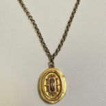 A Victorian two tone yellow metal locket with Etruscan revival style beading and wirework