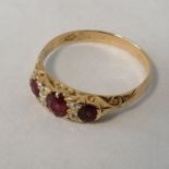 A ruby and diamond half hoop ring, with carved raised mount in the Victorian style. With scratched