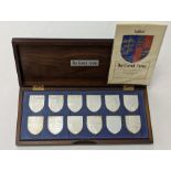A cased box of 12 Silver Royal coat of arms.  Through the ages in celebration of Her Majesty the