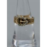 A Diamond set 9ct gold buckle ring. Although this is a later 20th century example, the buckle was
