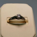 A diamond solitaire ring. Featuring an estimated 0.20 carat round brilliant cut diamond. Stamped "