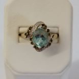 A topaz and diamond dress ring. In unmarked yellow metal. Size P. Gross weight approximately 4.0