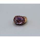 An amethyst set Italian dress ring in rose-pink metal. Featuring a rose/mixed cut central