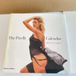 A large collection of approximately 14 Pirelli Calendars and a Pirelli Book The Pirelli Calendar,