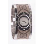 Gucci- a ladies Gucci 'Twirl' dress watch, comprising a mother of pearl swivel dial, to a bangle