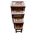 A contemporary nest of four occasional tables in the Chinoiserie style with carved detail and