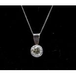 A diamond and 9ct white gold pendant, comprising a rub over set round brilliant cut diamond,