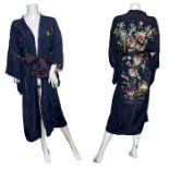 A striking reversible 1930s kimono robe made from rayon silk. The blue side is hand embroidered with