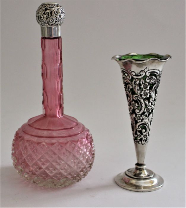 A Victorian cranberry cut glass globular scent bottle with tall slender neck, the Victorian silver