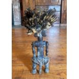 Baluba Tribal fertility male three faced statue in wood with a feather head dress.  He stands 27"