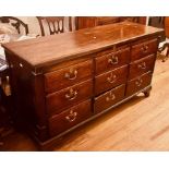 A George III oak Lancashire chest, hinged top lid above six faux over three drawers with later brass