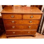 A George IV oak chest of drawers, rectangular shaped with moulded edge top, above two and three long