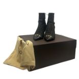 A pair of Louis Vuitton boots in monogrammed canvas with chocolate glace leather heels and toes