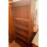 A Chippendale revival mahogany open bookcase, dentil cornice above adjustable pin-fitted shelves,