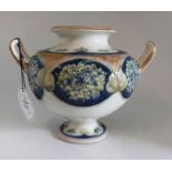 A boxed Macintyre pottery Lilac two handled urn signed in green W Moorcroft, and stamped Macintyre