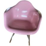 Manner of Charles & Ray Eames fibreglass, chrome and wooden feet pink tub rocking chair, by