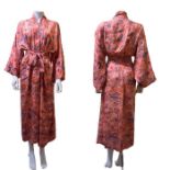 A 1930s silk kimono robe, Japanese, in a coral shade with printed design in blue, orange,