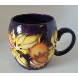 Moorcroft "Endagered species" mug decorated with conkers on a purple ground ,  9cm high