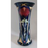 A boxed limited edition Orphir vase, made by Moorcroft. for Liberty's  Decorated with a red flower