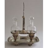 A Victorian silver rectangular two bottle cruet stand with rounded corners with cast central