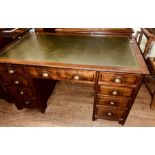 An early 20th century mahogany kneehole partners style desk, leather inlay top with a moulded edge