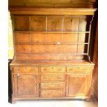 A George III oak dresser and rack, moulded cornice over plain frieze and three shelves with