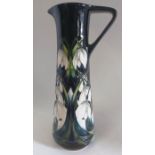 A Limited edition jug is decorated in a pattern called  " Winter Cascade " and made by Moorcroft.
