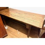 A George III oak and elm farmhouse table, four plank top with cleated ends, raised on square