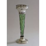 An Edwardian silver bud vase with pierced rim and body, pedestal foot, green glass liner, London