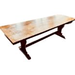 An oak refectory table, three plank top with cleated ends, raised on pin joined trestle supports