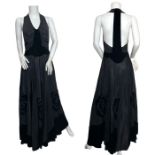 A 1930s T back evening gown in black taffeta and velvet with a more than full circle skirt with