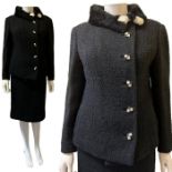 An early 1960s boucle suit with mouton collar and carved chequerboard buttons, Kashmoor labelled. (