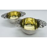 A pair of Edward VII quaich form sterling silver salts with blue glass liners. Hallmarked for