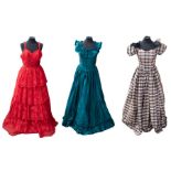A collection of ballgowns to include: a red lace tiered gown from the late 1950s/early 1960s, size