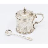 A Victorian silver drum shaped mustard pot and cover, the body engraved with ornate panels with