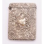 An Edwardian silver card case, the body chased and engraved with scrolling foliate, latticework