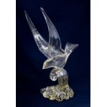 Large glass figure of bird riding waves. Artist marks to base.