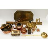 A large collection of brass and copper wares, including pots, money tins, fire irons, scales,