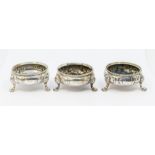 A matched set of three Victorian silver salts, beaded border above bodies chased with flowers,