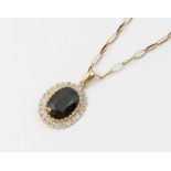 A sapphire and diamond 9ct gold pendant, comprising an oval mixed cut dark sapphire approx 13 x