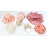 A collection of hats to include: a large dusky pink picture hat decorated with a large pink raffia