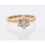 A diamond and 9ct gold cluster ring, comprising a floral arrangement of round brilliant cut