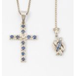 A sapphire and diamond cross claw set with round mixed cut sapphires, the centre set with a round
